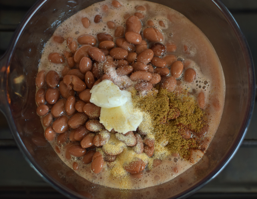 pinto beans in pot with butter and spices